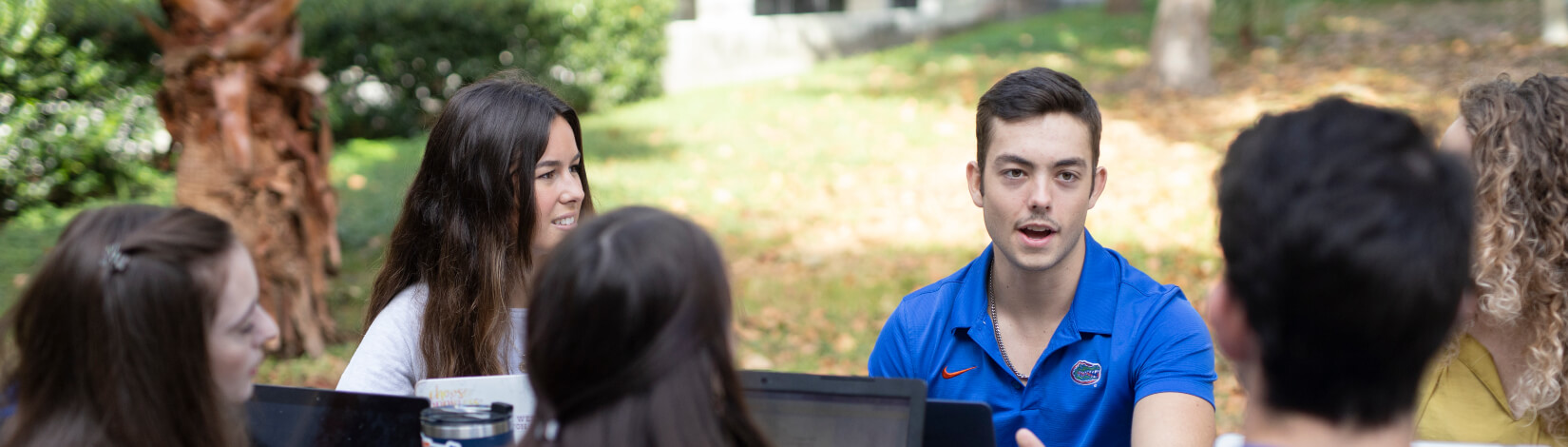 students having a conversation in the park